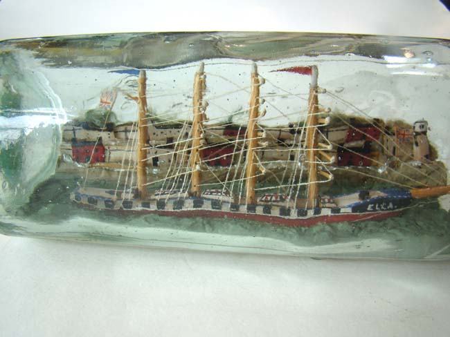 A Wonderful Antique Ship-in-a Bottle being lead into harbor by a pilot boat circa 1900